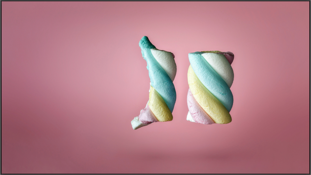 Colour photograph of twisted marshmallow candy on a pink background, satirical still life on junk food, by Tom Parsons