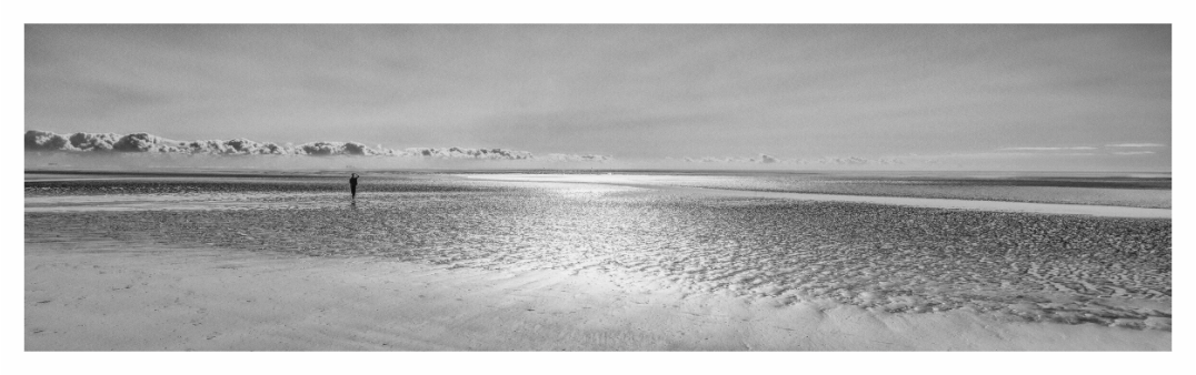 Camber Sands print, 244 × 70 cm with white border — lone figure on the wide open beach at Camber Sands, East Sussex, black and white landscape photography by Tom Parsons