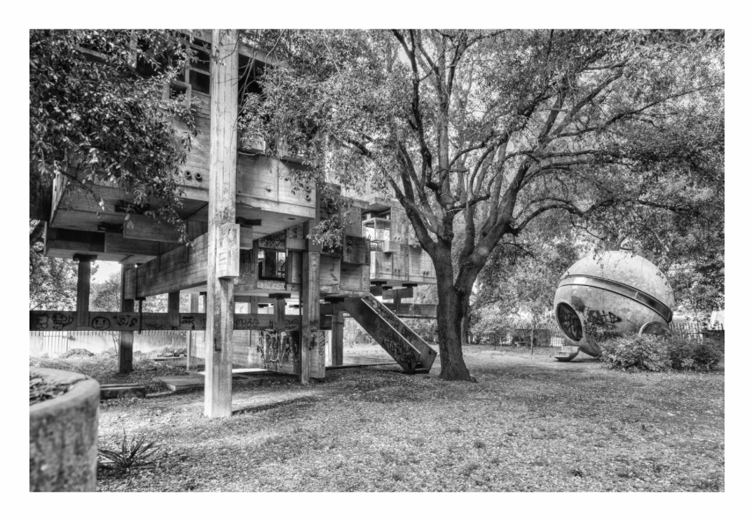 Casa Sperimentale print, 120 × 80 cm with white border — Casa Sperimentale's raised concrete platform and pod-shaped module beneath a tree, Fregene, black and white architecture photography by Tom Parsons