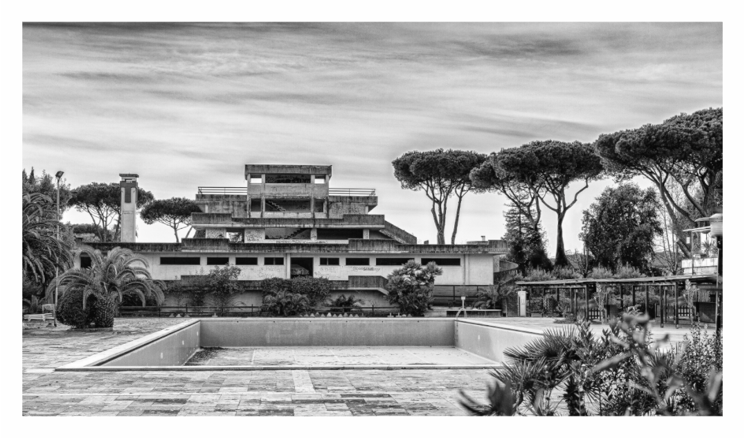 Abandoned Lido print, 160 × 90 cm with white border — an empty pool and derelict modernist lido building, Casal Palocco, Rome, black and white architecture photography by Tom Parsons