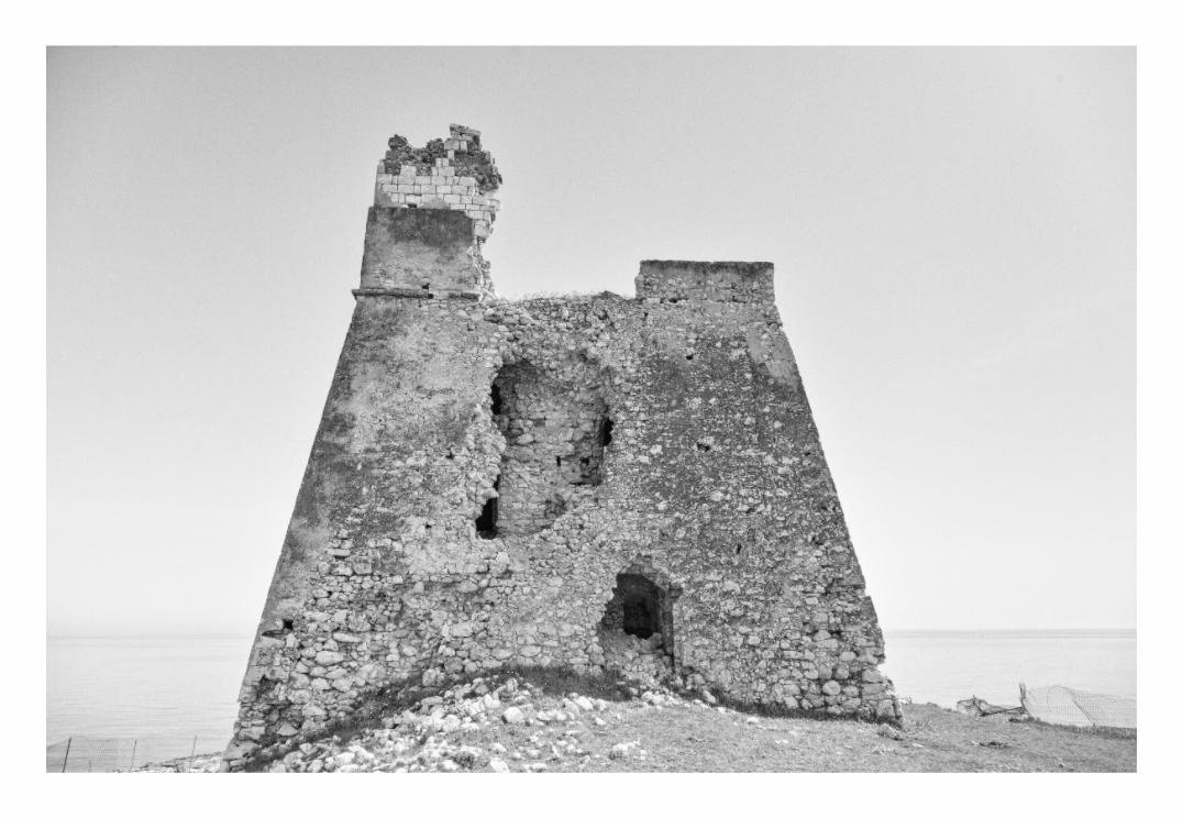 Fortress in Puglia print, 120 × 80 cm with white border — a ruined coastal watchtower fortress overlooking the sea, Puglia, black and white architectural photography by Tom Parsons
