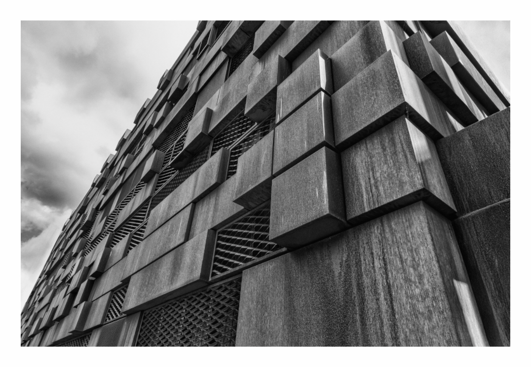 Steel Cladding print, 120 × 80 cm with white border — angular steel cladding on a modern Manchester building, low angle view, black and white architecture photography by Tom Parsons