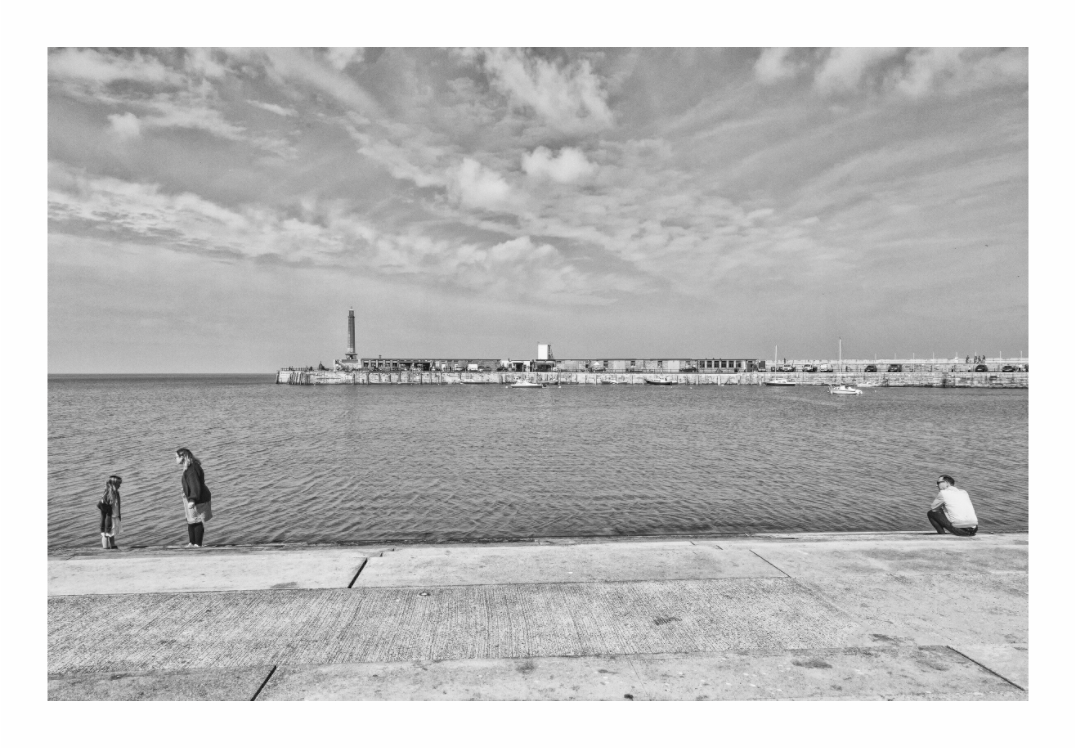 Steps print, 105 × 70 cm with white border — two adults and a child on the Victorian steps at Margate beach, opposite the harbour arm, black and white street photography by Tom Parsons