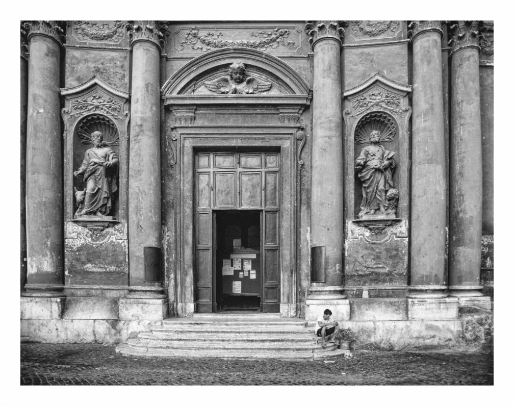 Italian Church print, 116.7 × 90 cm with white border — young man sitting on the steps of a church in Trastevere, Rome, Italy, black and white street photography by Tom Parsons