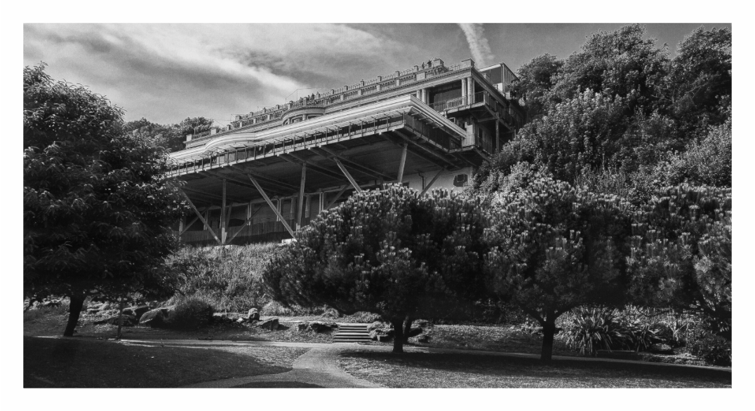 Leas Cliff Hall print, 155.1 × 80 cm with white border — the cantilevered structure rising above trees, Folkestone, Kent, black and white architecture photography by Tom Parsons