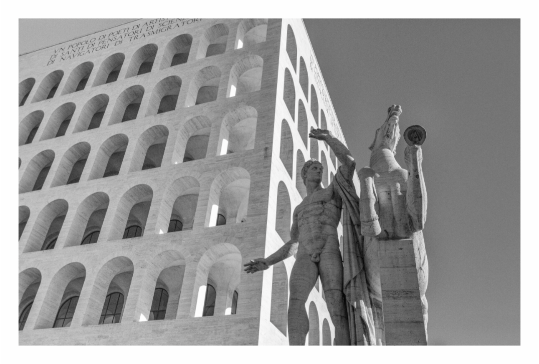 Palazzo della Civiltà Italiana print, 137.8 × 90 cm with white border — the arched travertine facade with a classical statue in the foreground, Rome, black and white architectural photography by Tom Parsons