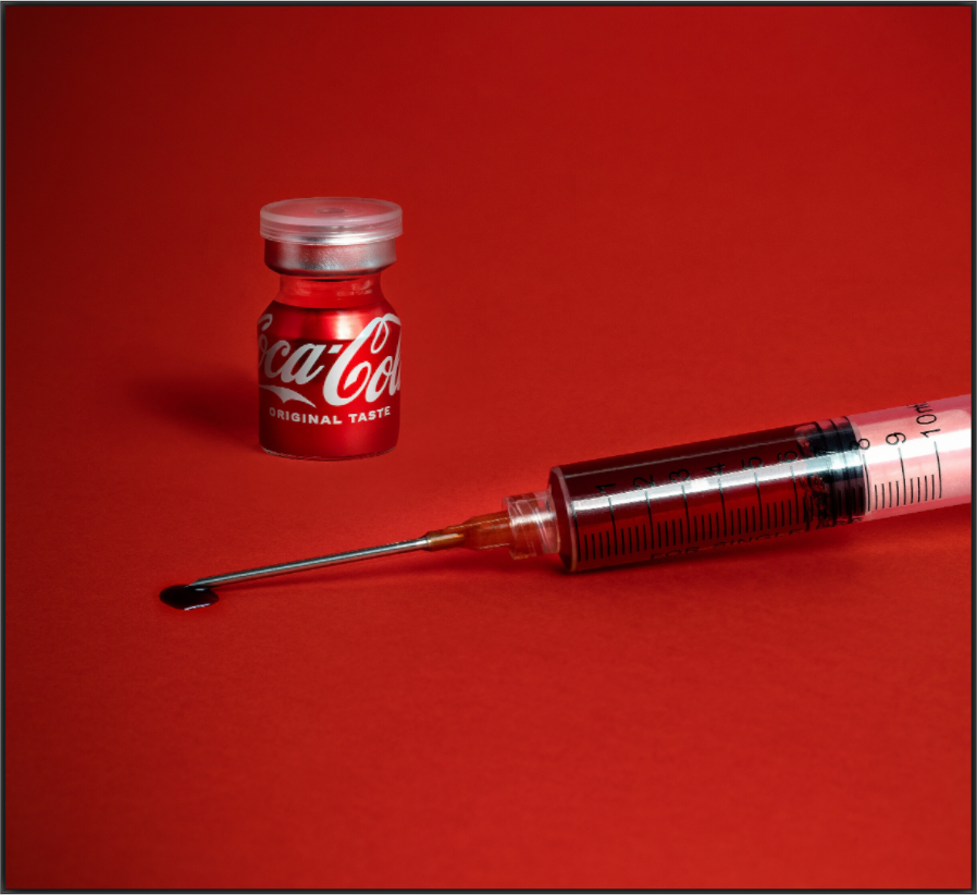 CocaCola print, 131.4 × 120 cm framed — colour photograph of a Coca-Cola bottle styled as a medicine vial beside a syringe on a red background, satirical still life by Tom Parsons