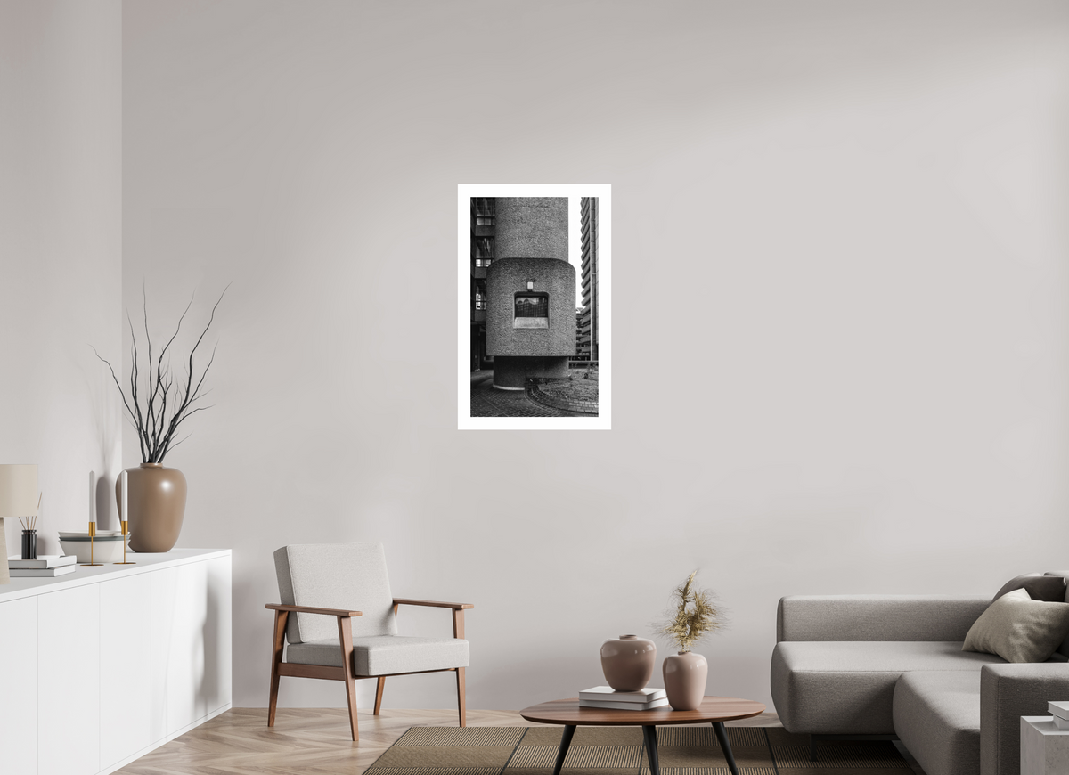 The Barbican print, 50 × 86 cm on Hahnemühle FineArt Pearl — a cylindrical concrete stair tower rising between residential blocks, London, black and white architectural photography by Tom Parsons